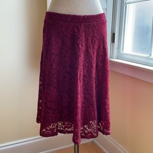Lace skirt, dark red and hits just above the knees